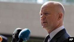 FILE - British Foreign Secretary William Hague addressees the media upon arrival at the EU foreign ministers council at the European Council headquarters in Luxembourg city, Luxembourg, June 23, 2014. 