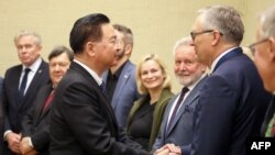 Taiwan Foreign Minister Joseph Wu, left, shakes hands with the members of the Foreign Affairs and European Affairs committees at the Seimas parliament in Vilnius, Lithuania, on Nov. 9, 2023. Officials of both countries say they have made progress in bilateral relations.