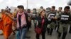 FILE - Cambodian civil rights supporters are forcibly directed by riot police as they march in protest of charges brought against local rights activists near Prey Sar prison, outside Phnom Penh, Cambodia, May 9, 2016.