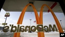 FILE - The McDonald's Golden Arches logo is placed on a window at a McDonald's restaurant.