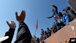 People protest during a rally on the central square in Bishkek, Kyrgyzstan, Oct. 7, 2020. 