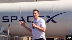 FILE - SpaceX CEO Elon Musk speaks SpaceX's Hyperloop track in Hawthorne, Calif., Aug. 27, 2017.