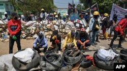 Demonstran membangun barikade selama aksi protes antikudeta di Yangon, Myanmar (20/3). 