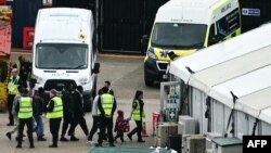 Migrants, including a child, picked up at sea attempting to cross the English Channel from France are escorted ashore in Dover, southeast England, on June 12, 2024.