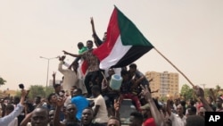 Sudanese shout slogans in a demonstration against the military council, in Khartoum, Sudan, June 30, 2019. Tens of thousands of protesters have taken to the streets in Sudan's capital and elsewhere calling for civilian rule.