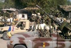 FILE - Chadian soldiers drive through the streets of Gambaru, Nigeria, Feb. 4, 2015.