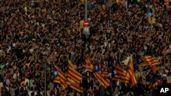 Protesters with ''esteladas'' or Catalonia independence flags pack the University square during a one-day strike in Barcelona, Spain, Tuesday Oct. 3, 2017. 