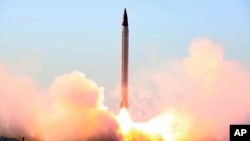 This file picture released by the official website of the Iranian Defense Ministry on Sunday, Oct. 11, 2015, claims to show the launching of an Emad long-range ballistic surface-to-surface missile in an undisclosed location.