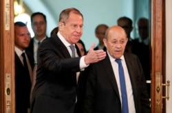 Russian Foreign Minister Sergei Lavrov and his French counterpart Jean-Yves Le Drian arrive for a meeting of the Russian-French Security Cooperation Council in Moscow, Russia, Sept. 9, 2019.