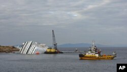 An oil recovery sea platform is seen next to the Costa Concordia cruise ship off the west coast of Italy, at Giglio island, January 26, 2012.