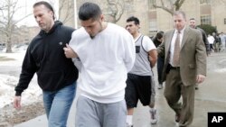 FILE - Suspected members of the MS-13 gang are escorted to their arraignment in Mineola, New York, Jan. 11, 2018.