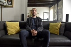 FILE - Khaled Drareni, Algerian journalist for France's TV5 Monde and NGO Reporters Without Borders (RSF), and who has become a symbol of the struggle for a free press, poses for a photo at his home in Algiers, Feb. 23, 2021.