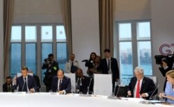 World leaders attend a session on climate change, in Biarritz, France, Aug. 26, 2019, on the third day of the annual G-7 Summit. The empty chair was reserved for U.S. President Donald Trump.