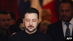 Ukraine's President Volodymyr Zelensky reacts as he leaves after attending a summit held at Lancaster House in central London on March 2, 2025.