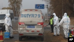 Workers disinfect passing vehicles in an area after the latest incident of African swine flu outbreak on the outskirts of Beijing, China, last November. A recent incident has Taiwan concerned about its spread.
