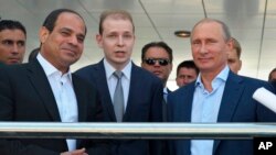 Russian President Vladimir Putin, right, and Egyptian President Abdel-Fattah el-Sissi, second left, listen to a translator during a meeting in the Russian Black Sea resort of Sochi, Russia, Aug. 12, 2014.