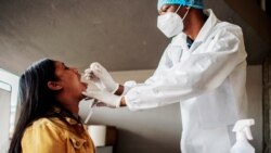 A nurse from Lancet Nectare hospital (R) performs a COVID-19 coronavirus test in Richmond, South Africa, Dec. 18, 2020. (Photo by LUCA SOLA / AFP)