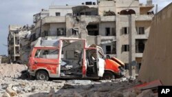 In this photo provided by the Syrian Civil Defense group known as the "White Helmets," a destroyed ambulance is seen in the Ansari neighborhood in the rebel-held part of eastern Aleppo, Syria, Sept. 23, 2016.