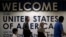 FILE - International passengers arrive at Washington Dulles International Airport, in Dulles, Virginia, June 26, 2017. 