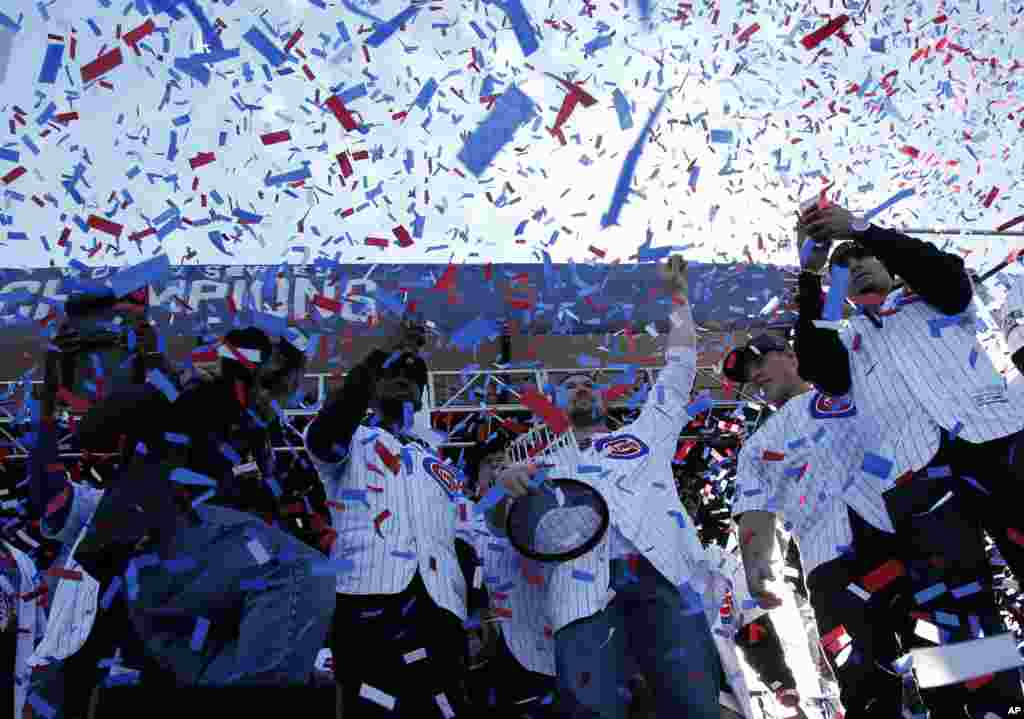 Chicago Cubs&#39; Jon Lester holds the Commissioners Trophy as he celebrates with teammates during a celebration honoring the World Series champions at Grant Park in Chicago, llinois.