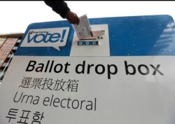 Voters drop off ballots in the Washington State primary, March 10, 2020 in Seattle.