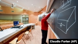 A teacher gives on-line lessons via webcam at the Politecnico University in Milan, Italy, Thursday, March 5, 2020.