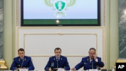 Aides from the Russian Prosecutor General office attend a news conference in Moscow, Russia, Nov. 19, 2018, announcing new charges against U.S.-born investment banker Bill Browder.