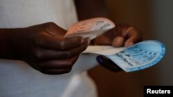 A voter casts his ballot in the general elections in Harare, Zimbabwe, July 30, 2018. 