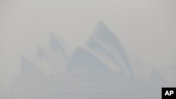 FILE- Thick smoke from wildfires shroud the Opera House in Sydney, Australia, Dec. 10, 2019. Hot dry conditions have brought an early start to the fire season. 