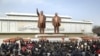 North Korean soldiers, workers and students place flowers before the statues of North Korean founder Kim Il-sung (L) and his son, late leader Kim Jong-il, on the 101st anniversary of Kim Il-sung's birth, at Mansudae in Pyongyang, in this photo distributed