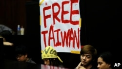 FILE - Students protesting against a China-Taiwan trade pact occupy the legislature floor, in Taipei, Taiwan, March 20, 2014.