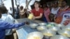 Catherine Bertini, former Executive Director of the World Food Programme (WFP), dishes out lunch to pupils, (File photo).
