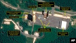 This July 22, 2018, satellite image released and annotated by 38 North on Monday, July 23, shows what the U.S. research group says is the partial dismantling of the rail-mounted transfer structure, at center, at the Sohae launch site in North Korea. (Airbus Defense & Space/38 North via AP)