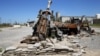 A burned Humvee and artillery are seen at the peshmerga base in Makhmour, after it was freed from control of Islamic State militants, south of Mosul, April 17, 2016. 