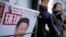 Women walk past a news stand displaying a Chinese news magazine fronting a photo of Chinese President Xi Jinping and U.S. President Donald Trump in Beijing, Feb. 9, 2017.