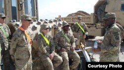 Dawud Agbere (kanan), yang fasih Bahasa Arab dan seringkali menjadi satu-satunya Muslim dalam pasukannya, mengatakan ia ingin menjembatani kesenjangan antar budaya. 