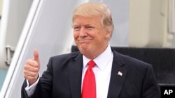 FILE - President Donald Trump gestures as he walks down the stairs of Air Force One upon his arrival at Palm Beach International Airport in West Palm Beach, Fla., March 3, 2017. China has granted preliminary approval for 38 new Trump trademarks, fueling c