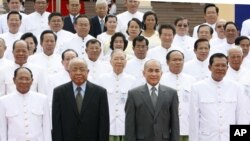 FILE PHOTO - Cambodia's King Norodom Sihamoni, second right, poses for photograph altogether with Hun Sen, right, Cambodian Prime Minister, Chea Sim, second left, Cambodia Senate President, Heng Samrin, left, Cambodian National Assembly President, in front of the National Assembly in Phnom Penh, Cambodia.
