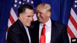 Donald Trump greets Republican presidential candidate, former Massachusetts Gov. Mitt Romney Feb. 2, 2012, in Las Vegas.