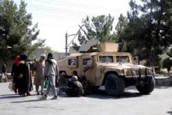 FILE - Taliban fighters guard outside the airport in Kabul, Afghanistan, Aug. 27, 2021, a day after a suicide bomb attack on the perimeter of the airport.