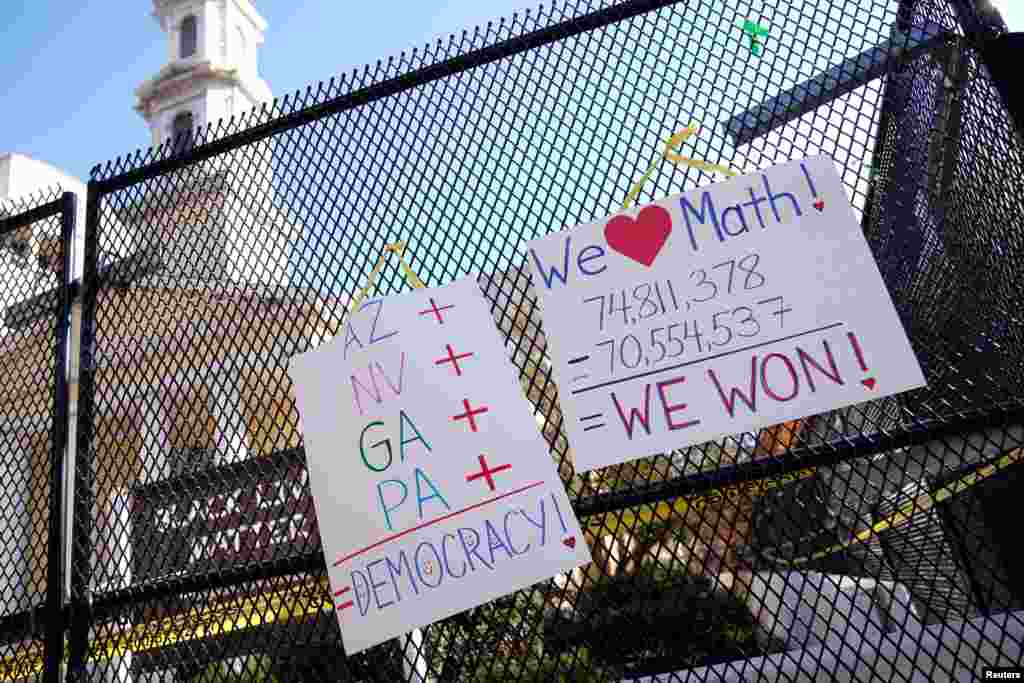 Posters displaying election results hang on the fence outside of St. John&#39;s Church near the White House, in Washington, Nov. 8, 2020. 