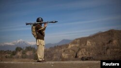 FILE - A Pakistani soldier holds a rocket launcher while securing a road in the town of Khar, in Pakistan's Federally Administered Tribal Areas (FATA), March 2, 2010. The FATA areas now have become part of Pakistan's Khyber Pakhtunkhwa province. 