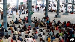 Migrant laborers, who arrived from Gujarat state on a train, are seen before proceeding for their native villages in their home state of Uttar Pradesh in Prayagraj, India, May 6, 2020.
