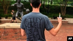 David Belnap, a sophomore at the University of North Carolina at Charlotte, attends a candlelight vigil, May 1, 2019, in support of Riley Howell, a classmate who was killed while confronting a gunman inside a classroom.
