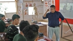 Arakan Army Deputy Commander Nyo Tun Aung instructs a class of recruits in emergency medical treatment.