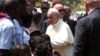 Pope Francis greets internally displaced people sheltering on the grounds of the Saint Sauveur church, during his visit in the capital Bangui, Central African Republic, Nov. 29, 2015.