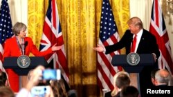  FILE - British Prime Minister Theresa May and U.S. President Donald Trump during their joint news conference at the White House in Washington, Jan. 27, 2017. Both the Trump presidential campaign and the Brexit campaign used Big Data to reach voters. (REUTERS/Kevin Lamarque/Files)