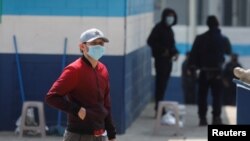 Guatemalan migrants who arrived in the country on U.S. deportation flights wear protective masks at a temporary shelter, as the spread of the coronavirus disease (COVID-19) continues in Guatemala City, April 18, 2020.