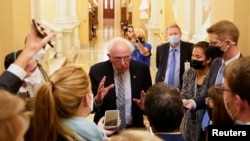 FILE - Senator Bernie Sanders (I-VT) speaks to reporters at the U.S. Capitol building on Capitol Hill in Washington, Sept. 30, 2021.