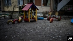 Shards of window glass are seen in the kindergarten at the scene where a helicopter crashed on civil infrastructure in Brovary, on the outskirts of Kyiv, Ukraine, Jan. 18, 2023. 